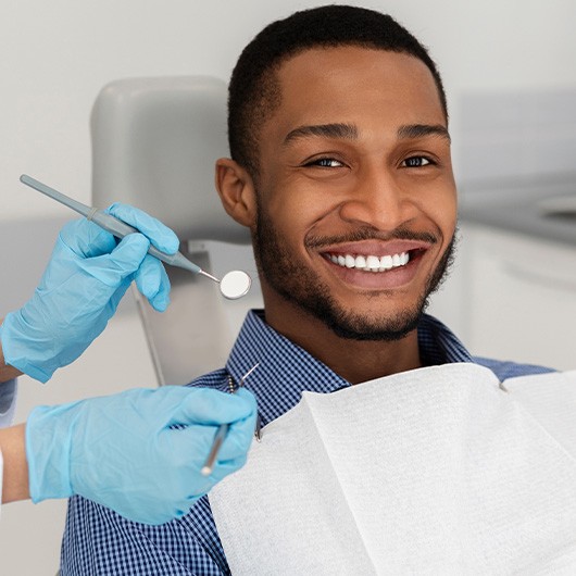 Patient in Arlington Heights smiling with healthy, protected teeth