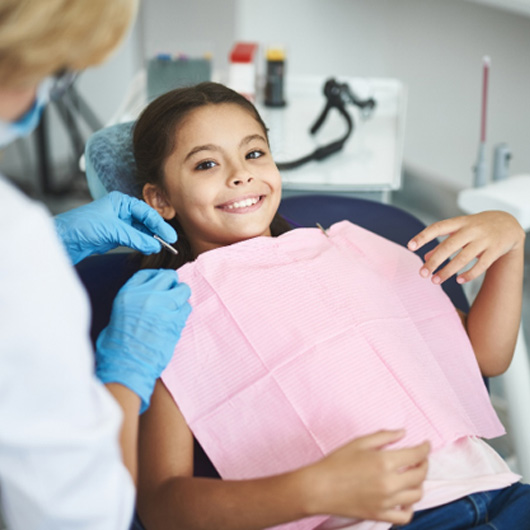 Child smiling in the dental chair