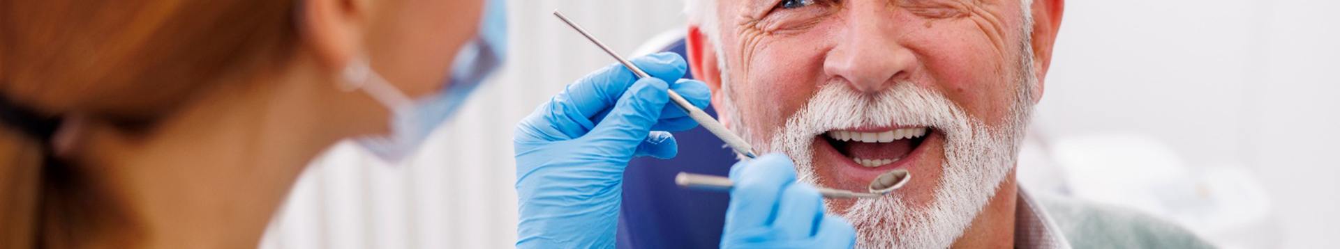Man smiles at dentist
