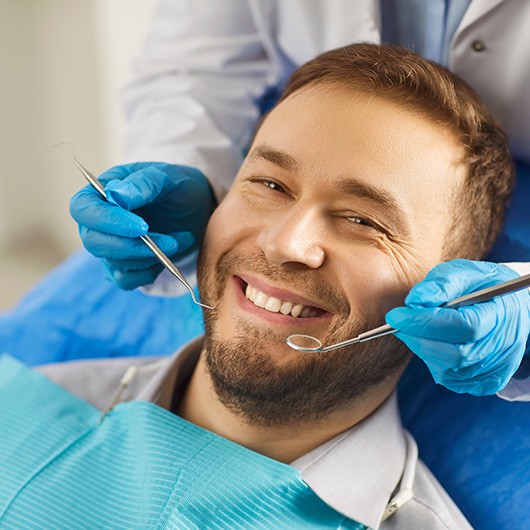 a smiling dental patient after a root canal