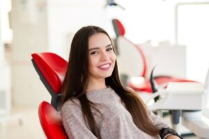 Smiling cosmetic dentistry patient in treatment chair