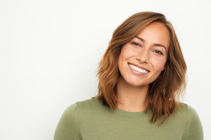 Woman in green shirt showing off her white smile